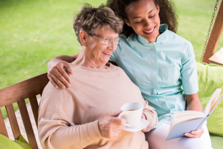 caregiver and senior reading