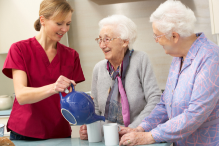 caregiver and seniors taking coffee