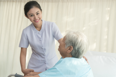 senior and nurse smilng